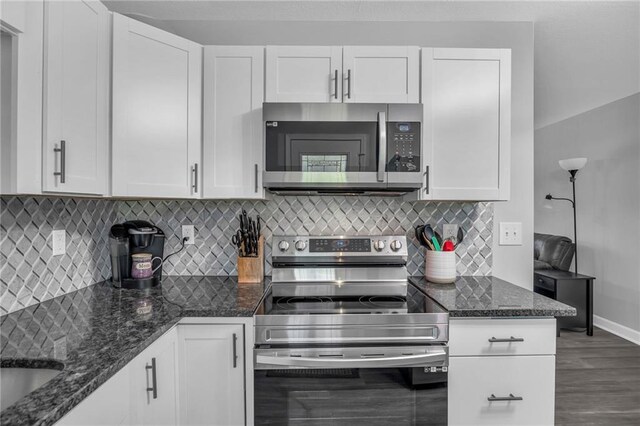 835 N 83rd Dr, Kansas City, KS 66112 - kitchen with stainless steel appliances, white cabinetry, and baseboards