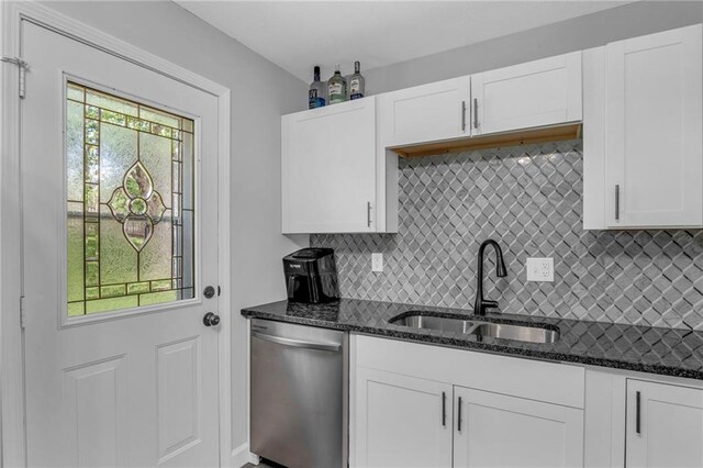 835 N 83rd Dr, Kansas City, KS 66112 - kitchen featuring dishwasher, a sink, decorative backsplash, and dark stone countertops