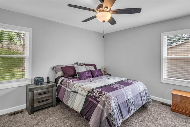 835 N 83rd Dr, Kansas City, KS 66112 - bedroom with carpet, multiple windows, baseboards, and a ceiling fan