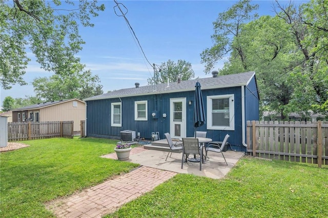 835 N 83rd Dr, Kansas City, KS 66112 - back of house with central AC unit, a patio area, roof with shingles, and board and batten siding