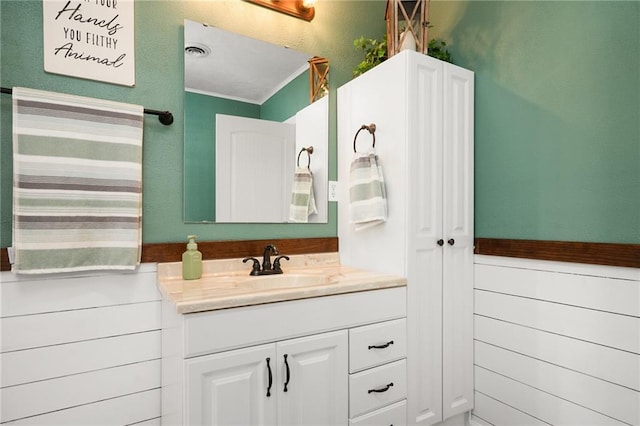 16805 266th Rd, Atchison, KS 66002 - bathroom with vanity, wainscoting, and ornamental molding
