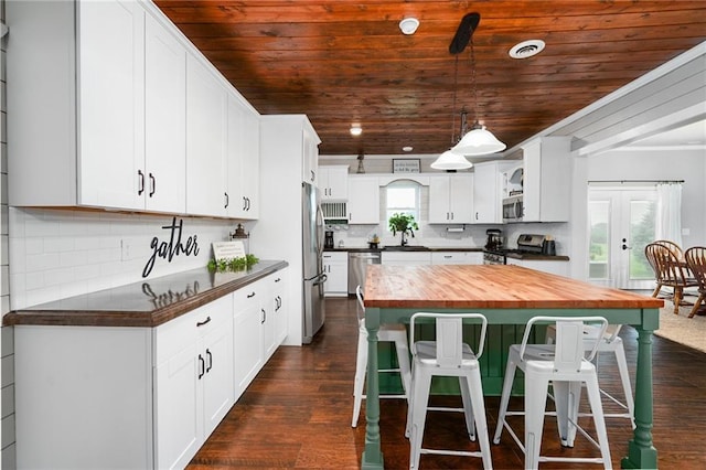 16805 266th Rd, Atchison, KS 66002 - kitchen with butcher block countertops, wooden ceiling, stainless steel appliances, a breakfast bar area, and french doors