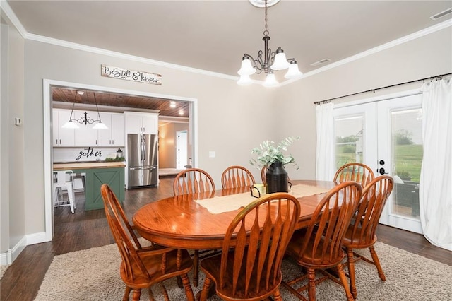 16805 266th Rd, Atchison, KS 66002 - dining area with a chandelier, crown molding, dark wood-type flooring, french doors, and baseboards