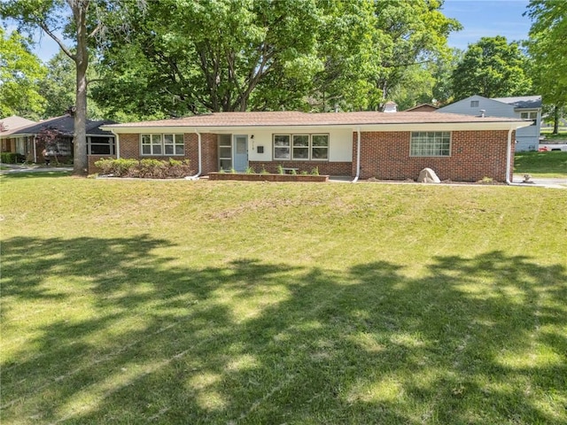 single story home with brick siding and a front lawn