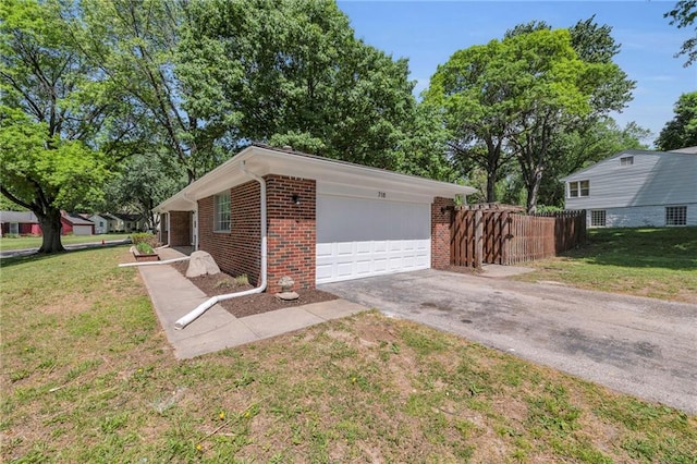 view of front of home featuring brick siding, asphalt driveway, and a garage