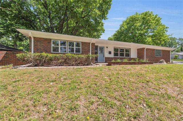 ranch-style house featuring brick siding and a front lawn