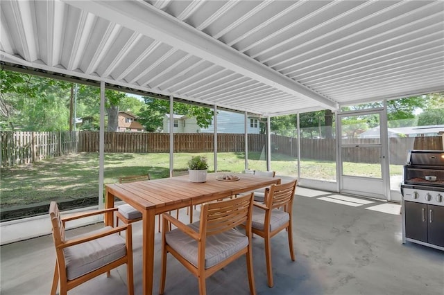 sunroom featuring outdoor dining area