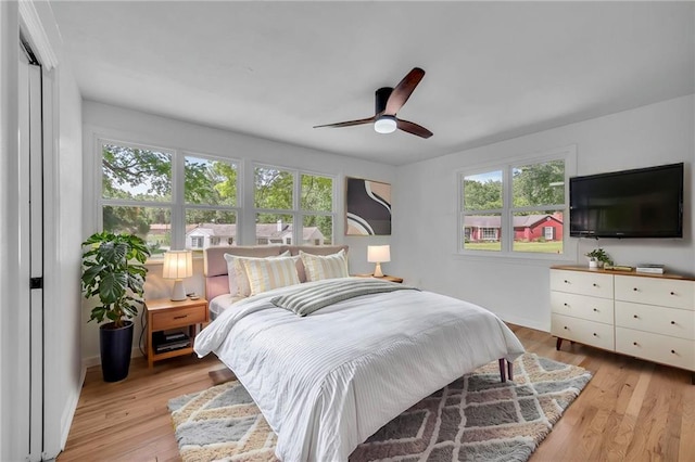 bedroom featuring light wood-style floors and a ceiling fan