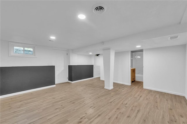 below grade area with light wood-style floors, baseboards, and recessed lighting