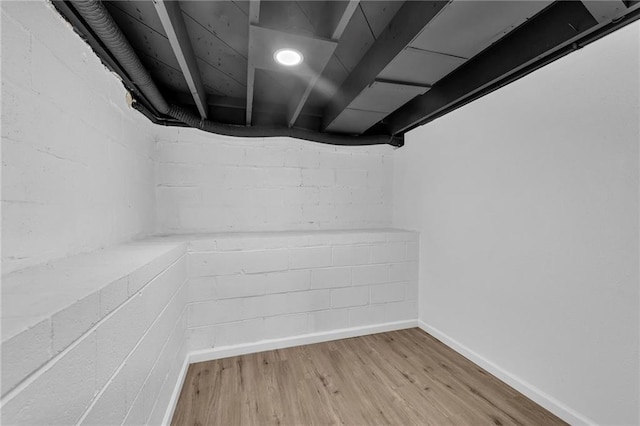 finished basement featuring wood finished floors and baseboards