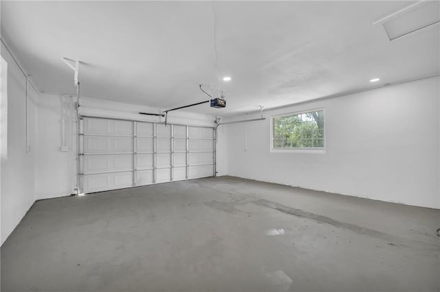 garage with a garage door opener and recessed lighting