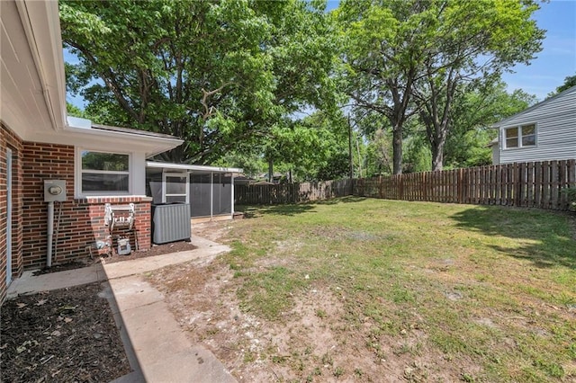 view of yard featuring a sunroom and cooling unit