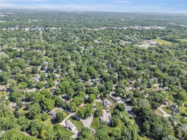 aerial view of property and surrounding area featuring a forest