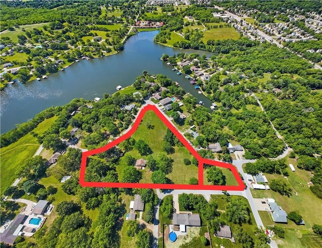 1717 NE Luther Rd, Lees Summit, MO 64086 - aerial view of property and surrounding area featuring a large body of water and property parcel outlined
