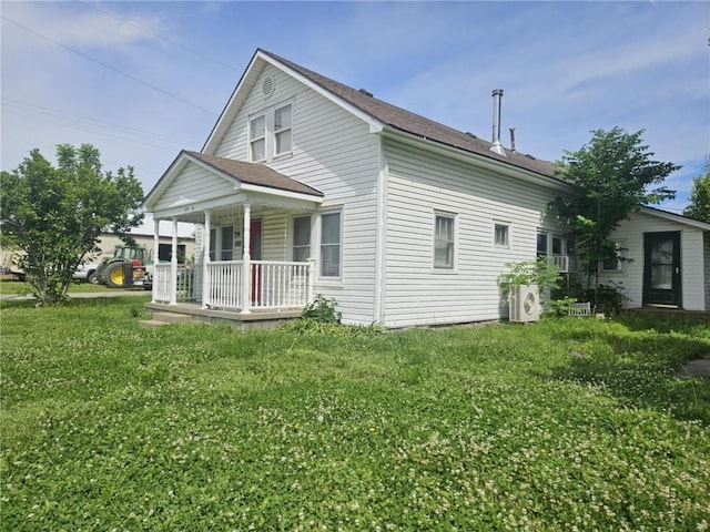 201 2nd St, Uniontown, KS 66779 - view of front of home with a porch, a front yard, a cooling unit, and roof with shingles