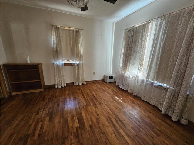 201 2nd St, Uniontown, KS 66779 - spare room with wood finished floors, a ceiling fan, and a textured ceiling