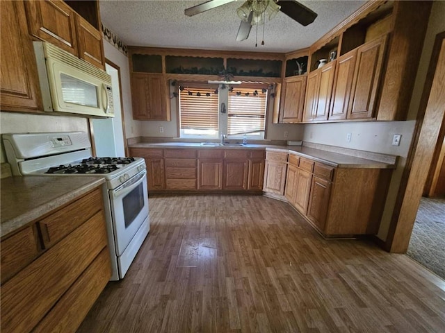 201 2nd St, Uniontown, KS 66779 - kitchen with white appliances, open shelves, a textured ceiling, dark wood-type flooring, and brown cabinets