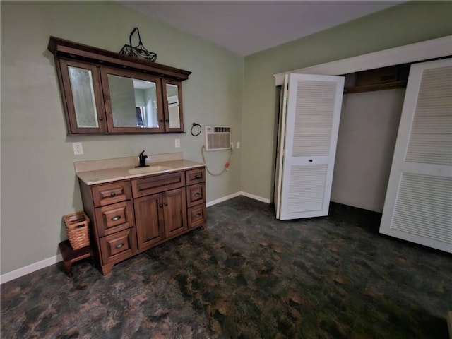 201 2nd St, Uniontown, KS 66779 - bathroom with a wall mounted AC, vanity, and baseboards