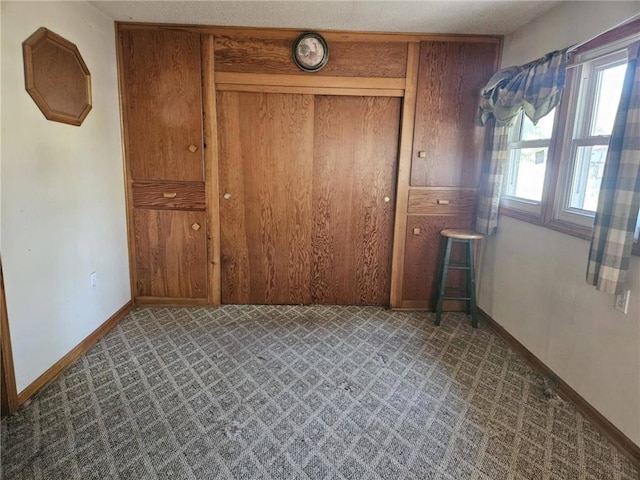 201 2nd St, Uniontown, KS 66779 - unfurnished bedroom featuring baseboards, carpet floors, and a closet