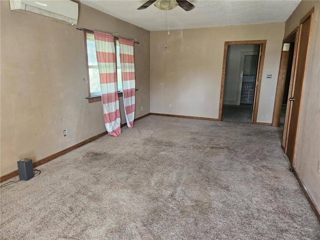 201 2nd St, Uniontown, KS 66779 - carpeted spare room featuring an AC wall unit, a ceiling fan, and baseboards