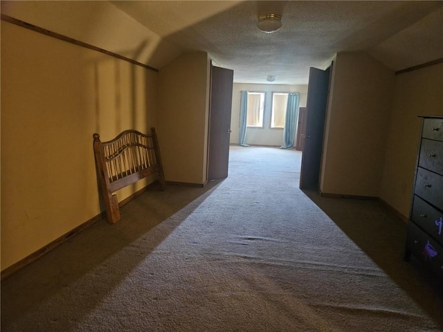 201 2nd St, Uniontown, KS 66779 - corridor with carpet floors, lofted ceiling, and baseboards