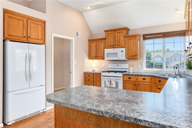 4107 Cavalry Ct, Leavenworth, KS 66048 - kitchen featuring white appliances, lofted ceiling, backsplash, a sink, and dark countertops