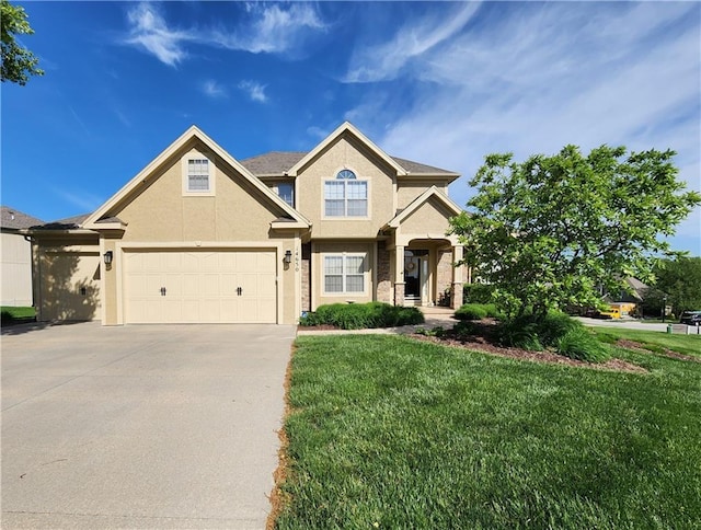 14650 NW 66th Ter, Parkville, MO 64152 - view of front of home with driveway, stucco siding, and a front lawn