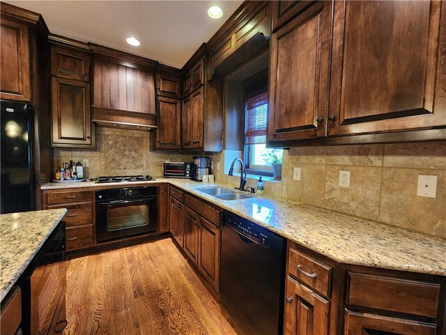 14650 NW 66th Ter, Parkville, MO 64152 - kitchen featuring black appliances, a sink, light wood finished floors, tasteful backsplash, and recessed lighting