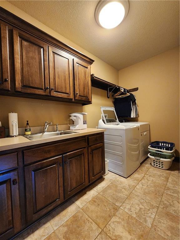 14650 NW 66th Ter, Parkville, MO 64152 - washroom with cabinet space and separate washer and dryer