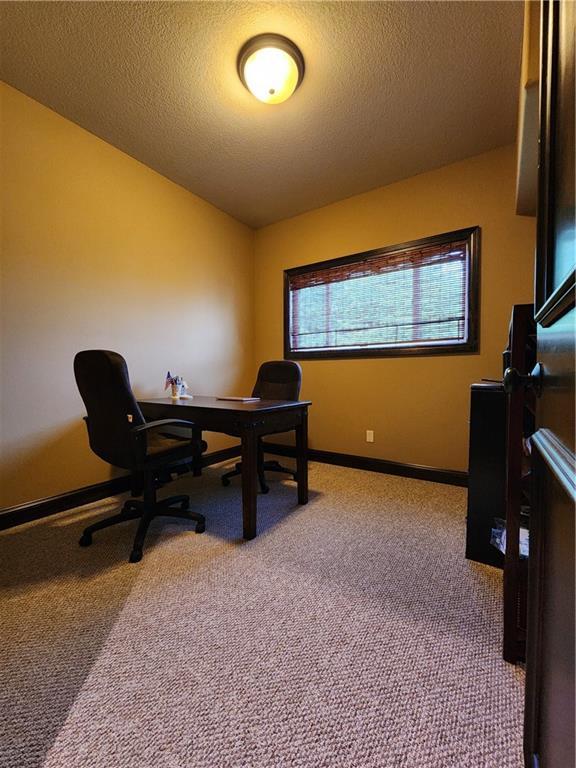 14650 NW 66th Ter, Parkville, MO 64152 - carpeted office with baseboards and a textured ceiling