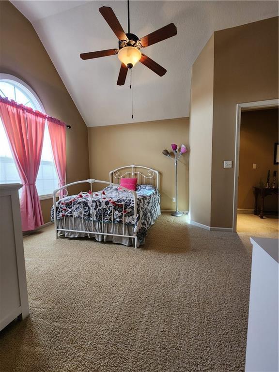 14650 NW 66th Ter, Parkville, MO 64152 - carpeted bedroom featuring lofted ceiling and ceiling fan