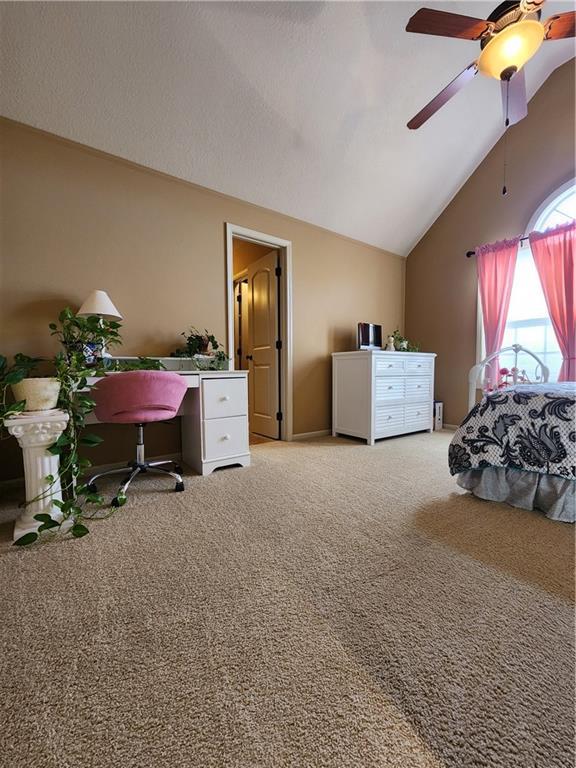 14650 NW 66th Ter, Parkville, MO 64152 - bedroom featuring light colored carpet, high vaulted ceiling, and a ceiling fan