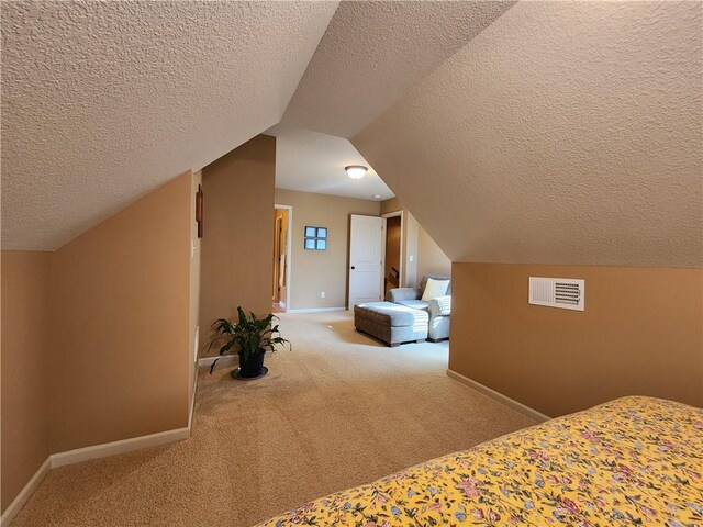 14650 NW 66th Ter, Parkville, MO 64152 - carpeted bedroom featuring baseboards, a textured ceiling, and lofted ceiling