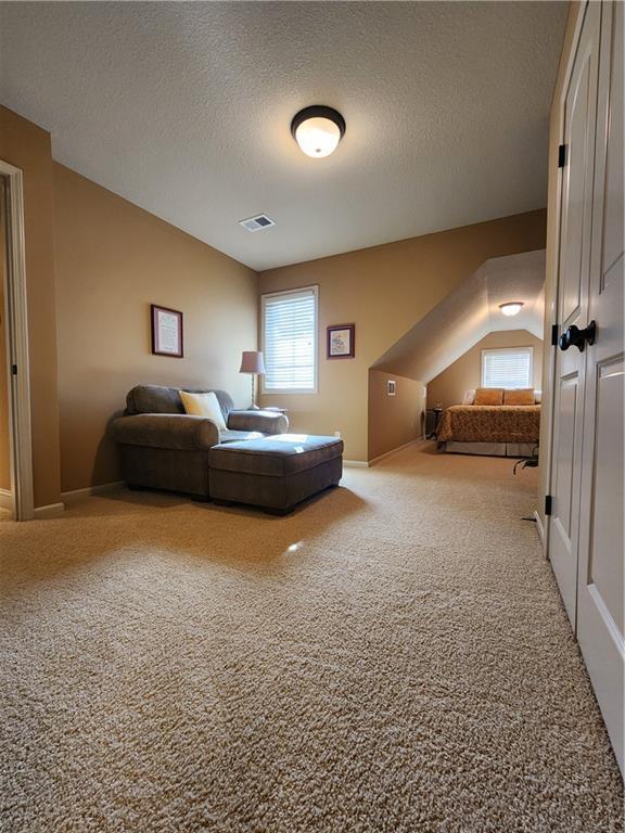 14650 NW 66th Ter, Parkville, MO 64152 - bedroom featuring carpet flooring, multiple windows, and a textured ceiling