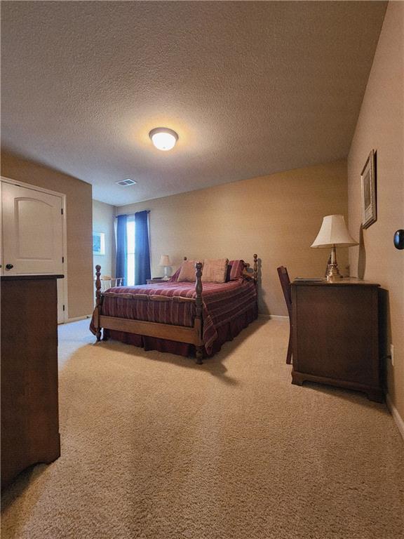 14650 NW 66th Ter, Parkville, MO 64152 - bedroom with light carpet and a textured ceiling