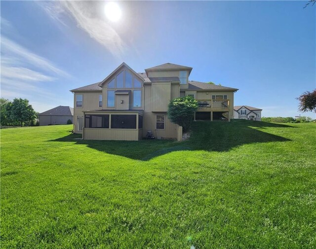 14650 NW 66th Ter, Parkville, MO 64152 - rear view of property with a lawn and a sunroom