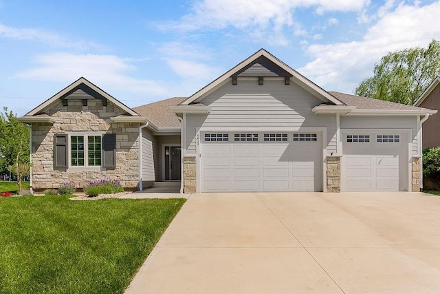 4403 Goldfield St, Lawrence, KS 66049 - view of front of home featuring stone siding, an attached garage, driveway, and a front lawn