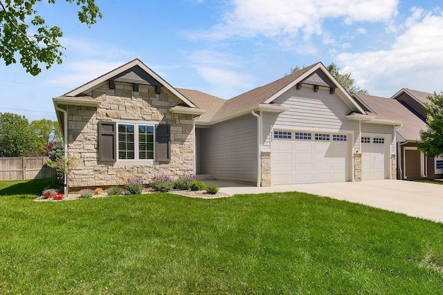 4403 Goldfield St, Lawrence, KS 66049 - view of front of house featuring stone siding, an attached garage, and driveway