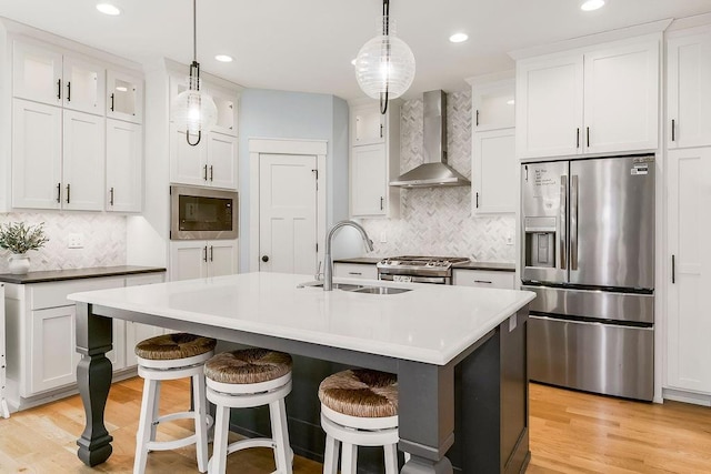 4403 Goldfield St, Lawrence, KS 66049 - kitchen featuring stainless steel appliances, wall chimney exhaust hood, a sink, glass insert cabinets, and recessed lighting
