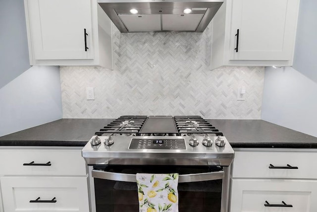 4403 Goldfield St, Lawrence, KS 66049 - kitchen featuring stainless steel gas stove, wall chimney exhaust hood, dark countertops, backsplash, and white cabinetry