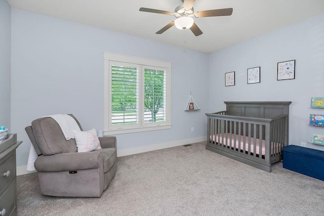 4403 Goldfield St, Lawrence, KS 66049 - carpeted bedroom featuring a crib, ceiling fan, and baseboards
