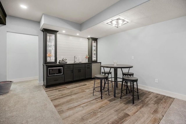 4403 Goldfield St, Lawrence, KS 66049 - indoor wet bar with stainless steel appliances, light wood-style floors, recessed lighting, and baseboards