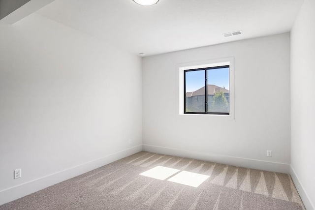 unfurnished room featuring light colored carpet and baseboards