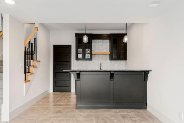 bar with stairway, decorative backsplash, light tile patterned flooring, baseboards, and recessed lighting