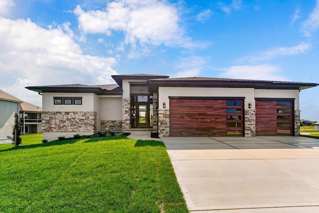 view of front of property featuring stone siding, stucco siding, an attached garage, and a front lawn