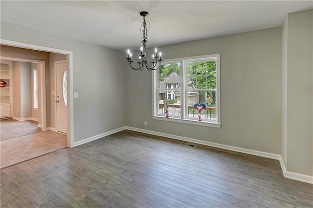 16253 W Briarwood Ct, Olathe, KS 66062 - unfurnished room featuring a chandelier, wood finished floors, and baseboards