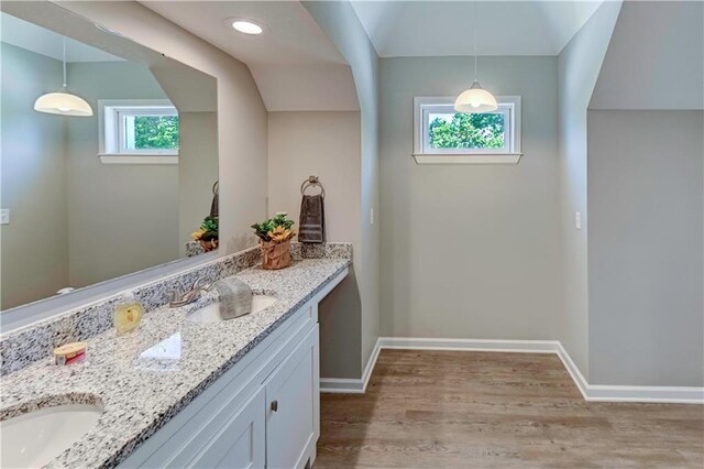 16253 W Briarwood Ct, Olathe, KS 66062 - bathroom featuring double vanity, wood finished floors, baseboards, and lofted ceiling