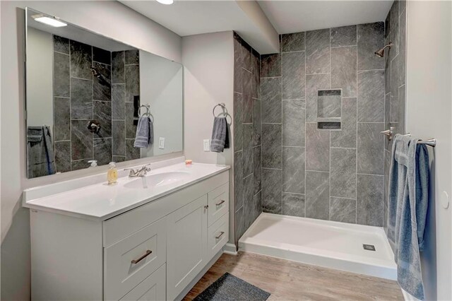 16253 W Briarwood Ct, Olathe, KS 66062 - bathroom with wood finished floors, a tile shower, and vanity