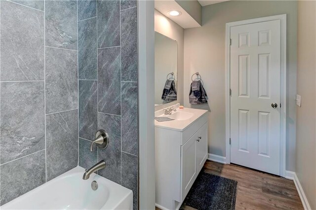 16253 W Briarwood Ct, Olathe, KS 66062 - bathroom featuring wood finished floors, vanity, shower / bathtub combination, and baseboards