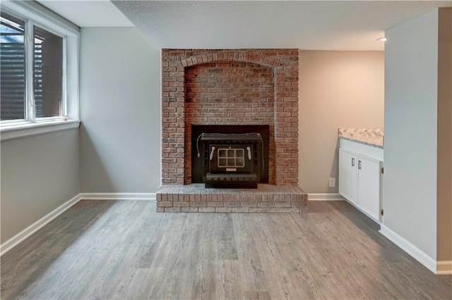16253 W Briarwood Ct, Olathe, KS 66062 - detailed view of wood finished floors, a wood stove, and baseboards